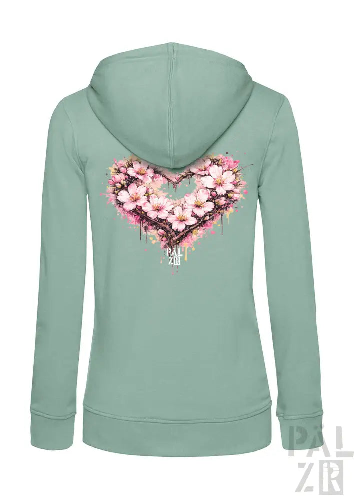 Eine minzgrüne Damen-Zipper-Hoodie mit einem lebendigen pinken Kirschblüten-Herz-Design auf dem Rücken.
