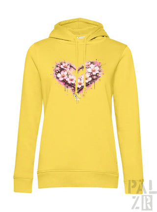 Ein lebendiges gelbes Damen-Hoodie mit einem herzförmigen Blumendesign mit pinken Blüten und Spritzfarbeffekten.