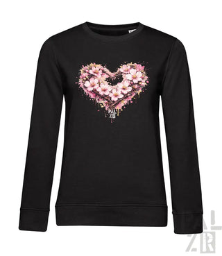 Schwarzes Langarm-Sweatshirt mit einem lebendigen pink-weißen Blumenherz-Design mit Spritzeffekten.
