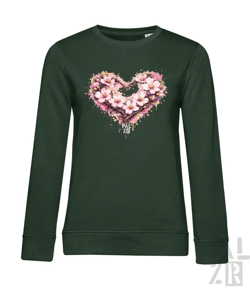 Dunkelgrünes Langarm-Sweatshirt mit einem lebendigen pink-weißen Blumenherz-Design mit Spritzeffekten.