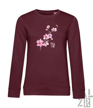 Maroon farbiger frauenpulli mit zartem rosa mandelzweig und pal zr markenlogo auf der vorderseite
