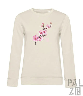 Beiger langärmliger frauen-pulli mit zartem mandelzweig in rosa auf der brust in verschiedenen farben erhältlich
