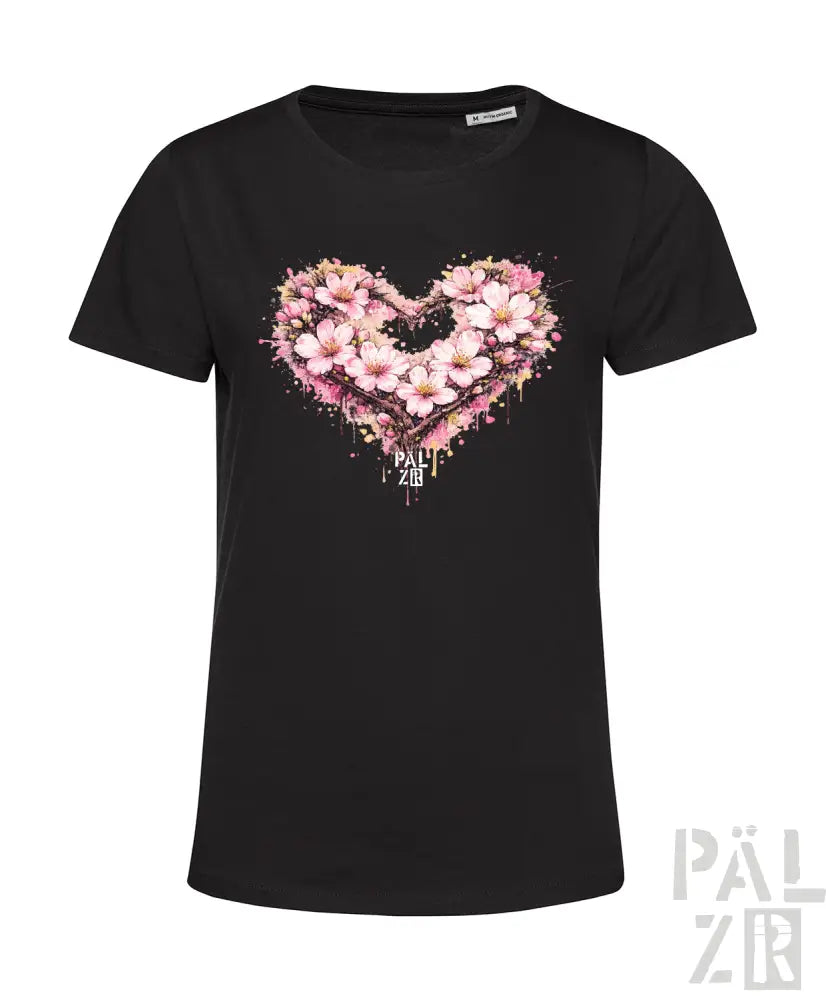 Schwarzes kurzärmeliges T-Shirt mit einem lebendigen pinken Blumenherz-Design mit Spritzeffekten und dem Markennamen ’pau zib’ gedruckt darunter.