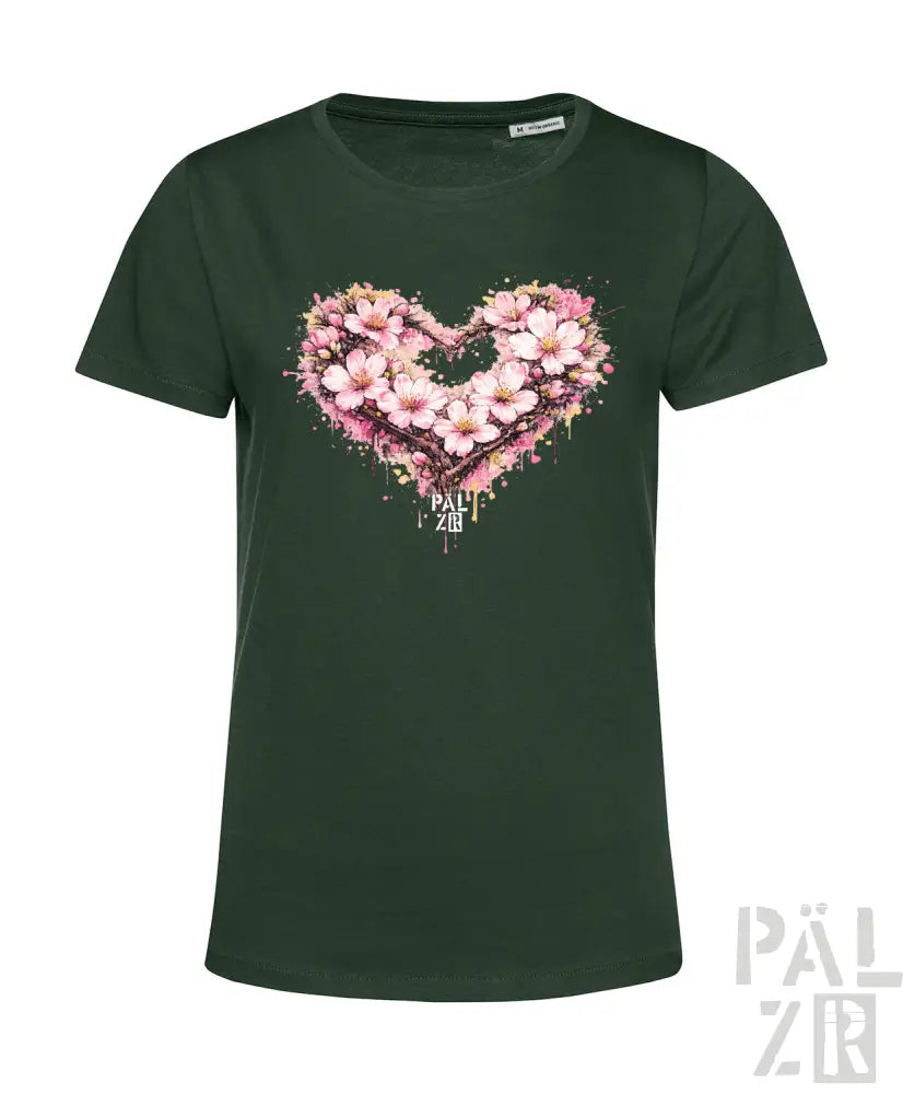 Dunkelgrünes Damen-T-Shirt mit einem lebendigen pinken Kirschblüten-Herz-Design mit Spritzeffekten und dem Text ’pal zib’ darunter.