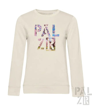 Creme-farbener Sweatshirt mit ’palzir’-Text in mehrfarbigem Blumenmuster.