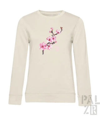 Cremeweißer Pullover mit rosa Kirschblüten-Design, Material aus Bio-Baumwolle.