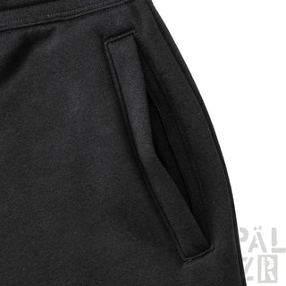 Schwarze getaschte Trackpants mit elastischem Bund und Kordelzug.