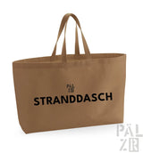 Beige Leinwand-Tragetasche mit schwarzem Text und Griffen, markiert ’stranddasch’ von pälzr.