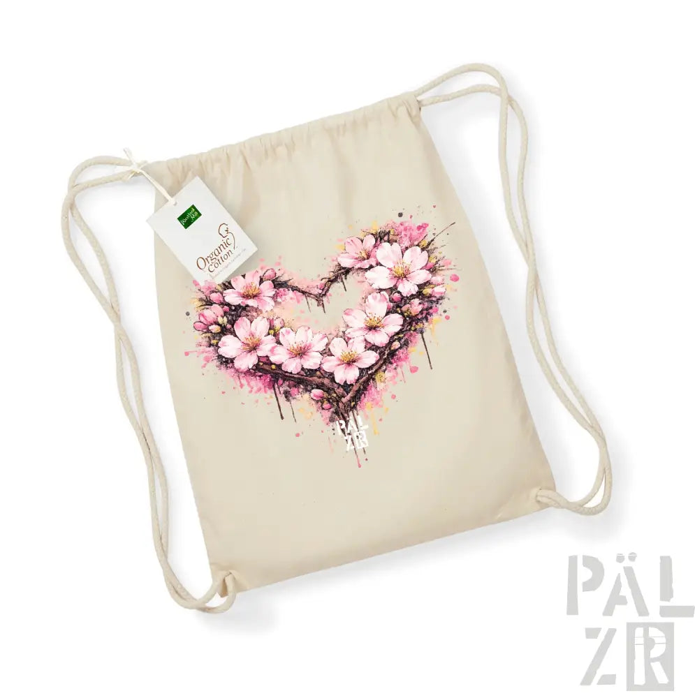 Beige Beutel aus Bio-Baumwolle mit Kordelzug, mit einem lebendigen pinken Kirschblüten-Herz-Design und Spritzereffekten.