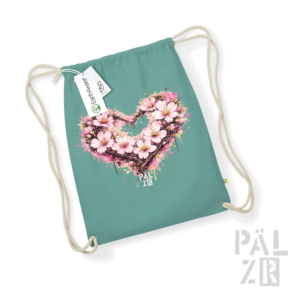 Teal-Ziehenkordtasche mit einem lebendigen pinken Kirschblüten-Herz-Design und Spritzeffekten.